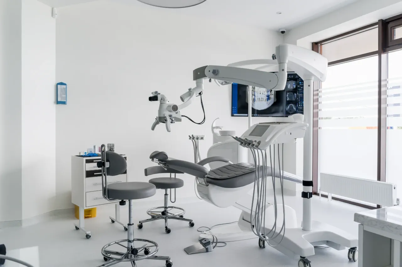 Dentist examining patient in dental chair